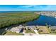 Aerial view of waterfront home with private dock and lush landscaping at 1454 Surfbird Ct, Punta Gorda, FL 33950