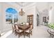 Elegant dining room featuring a large table, chandelier, and beautiful window at 1454 Surfbird Ct, Punta Gorda, FL 33950