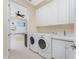 Convenient laundry room with washer, dryer, and ample storage at 1454 Surfbird Ct, Punta Gorda, FL 33950