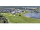 Aerial view of community with clubhouse, pool, golf course, and lake at 15100 River Birch Ct, Punta Gorda, FL 33955