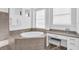 Relaxing bathroom with soaking tub and vanity at 15100 River Birch Ct, Punta Gorda, FL 33955