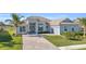 Single-story home with tile roof, paver driveway, and landscaped lawn at 15100 River Birch Ct, Punta Gorda, FL 33955