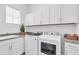 Bright laundry room with washer, dryer, and white cabinets at 15100 River Birch Ct, Punta Gorda, FL 33955