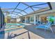 Inviting pool and spa with covered patio and lounge chairs at 15100 River Birch Ct, Punta Gorda, FL 33955