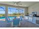 Outdoor kitchen and dining area with view of the pool at 15100 River Birch Ct, Punta Gorda, FL 33955