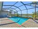 Relaxing screened pool and spa with lake view at 15100 River Birch Ct, Punta Gorda, FL 33955