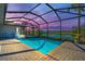 Screened pool and spa at sunset, beautiful lake view at 15100 River Birch Ct, Punta Gorda, FL 33955