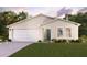 Two-car garage, teal front door, and well-manicured lawn at 1570 Hempstead Ave, North Port, FL 34286