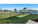 Landscaped backyard with lake view and fence at 17138 Anthem Ln, Punta Gorda, FL 33955