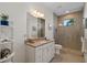 Bathroom with granite vanity and walk-in shower at 17138 Anthem Ln, Punta Gorda, FL 33955