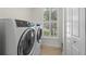 Laundry room with front-load washer and dryer, and window at 17138 Anthem Ln, Punta Gorda, FL 33955