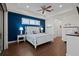 Main bedroom with blue accent wall, white bed, and hardwood floors at 17138 Anthem Ln, Punta Gorda, FL 33955