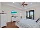 Main bedroom with a view, hardwood floors, and white bed at 17138 Anthem Ln, Punta Gorda, FL 33955