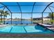 Relaxing pool and spa with a screened enclosure and lake view at 17138 Anthem Ln, Punta Gorda, FL 33955