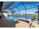 Gorgeous screened-in pool and jacuzzi overlooking the serene waterfront view and sunny skies at 17138 Anthem Ln, Punta Gorda, FL 33955