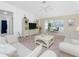 Comfortable living room with light-colored sofas and a view of dining area at 17521 Pomegrante Way, Punta Gorda, FL 33955