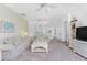 Living room with neutral-toned furniture, high ceilings, and a view of kitchen at 17521 Pomegrante Way, Punta Gorda, FL 33955