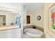 Bathroom with a large garden tub and double vanity at 1824 Dawnview St, North Port, FL 34288