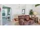 Living room with a brown leather couch and view of home office at 1824 Dawnview St, North Port, FL 34288