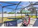 Screened patio with table, chairs, and grill at 1824 Dawnview St, North Port, FL 34288