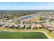 Wide aerial view of the community and lake at 1840 Bobcat Trl, North Port, FL 34288