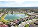 Aerial view of a neighborhood with houses surrounding a lake at 1840 Bobcat Trl, North Port, FL 34288