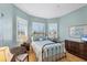 Serene bedroom with a metal bed frame and plenty of natural light at 1840 Bobcat Trl, North Port, FL 34288