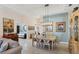 Elegant dining room with light colored furnishings and a view to the kitchen at 1840 Bobcat Trl, North Port, FL 34288