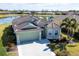 Single-Gathering home with a green exterior and tile roof at 1840 Bobcat Trl, North Port, FL 34288