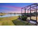 Screened-in patio area overlooking a lake at sunset at 1840 Bobcat Trl, North Port, FL 34288