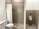 Updated bathroom with shower, toilet and urinal at 18506 Klingler Cir, Port Charlotte, FL 33948