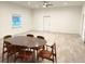 Open concept dining area with wood table and mid-century modern chairs at 18506 Klingler Cir, Port Charlotte, FL 33948