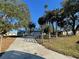 House with long driveway and trees at 18506 Klingler Cir, Port Charlotte, FL 33948