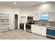 Modern white kitchen with stainless steel appliances and granite countertops at 18506 Klingler Cir, Port Charlotte, FL 33948