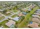 Expansive aerial shot of a residential area showcasing lush green lawns and diverse home styles in a sunny locale at 2149 Rio De Janeiro Ave, Punta Gorda, FL 33983