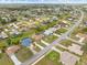 Aerial view of a residential neighborhood showcasing well-maintained homes and green landscapes at 2149 Rio De Janeiro Ave, Punta Gorda, FL 33983