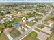 Overhead shot displays a well-planned community featuring neatly arranged homes, green spaces, and access to local streets at 2149 Rio De Janeiro Ave, Punta Gorda, FL 33983