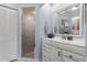 Bathroom with a shower, white cabinets, and a mirror at 2149 Rio De Janeiro Ave, Punta Gorda, FL 33983