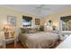 Bedroom with a ceiling fan, door to the outside, and light yellow walls at 2149 Rio De Janeiro Ave, Punta Gorda, FL 33983