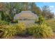 Entrance to the Deep Creek community featuring lush landscaping and a welcoming sign at 2149 Rio De Janeiro Ave, Punta Gorda, FL 33983