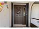 Stylish front door with glass and wreath; colorful decorations to the side at 2149 Rio De Janeiro Ave, Punta Gorda, FL 33983