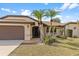 Exterior view of home with desert landscaping, a long driveway, and a two car garage at 2149 Rio De Janeiro Ave, Punta Gorda, FL 33983