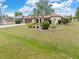 Exterior view of home with well maintained lawn and tropical landscaping at 2149 Rio De Janeiro Ave, Punta Gorda, FL 33983