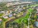 Aerial view of neighborhood, golf course, and pond at 2209 Calusa Lakes Blvd, Nokomis, FL 34275