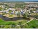 Community overview with golf course and lake at 2209 Calusa Lakes Blvd, Nokomis, FL 34275