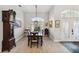 Bright dining area featuring a wood table and an elegant clock at 2209 Calusa Lakes Blvd, Nokomis, FL 34275