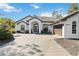 White house with a brown garage door and a paved driveway at 2209 Calusa Lakes Blvd, Nokomis, FL 34275