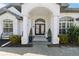 Elegant entryway with double doors, arched entry, and potted plants at 2209 Calusa Lakes Blvd, Nokomis, FL 34275