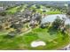 Aerial view of golf course, clubhouse, and pond at 2209 Calusa Lakes Blvd, Nokomis, FL 34275