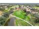 Aerial view of green with pond and houses at 2209 Calusa Lakes Blvd, Nokomis, FL 34275